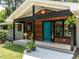 Welcoming covered porch with wood accents and a vibrant teal front door at 5809 Kimbal St, Raleigh, NC 27606