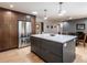 A modern kitchen with stainless steel refrigerator, spacious island, and open access to the dining area at 5809 Kimbal St, Raleigh, NC 27606