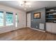 Bright living room featuring hardwood floors, built-in shelving, and a large picture window at 5809 Kimbal St, Raleigh, NC 27606