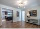 Open living space with hardwood floors flowing into adjacent room featuring a kitchen at 5809 Kimbal St, Raleigh, NC 27606