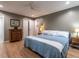 Comfortable main bedroom with hardwood floors, dresser, ceiling fan and stylish decor at 5809 Kimbal St, Raleigh, NC 27606