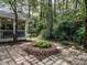 Brick patio with a fire pit and access to the home's screened porch at 5809 Kimbal St, Raleigh, NC 27606