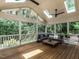 Inviting screened porch featuring comfortable seating and serene views of the surrounding landscape at 5809 Kimbal St, Raleigh, NC 27606