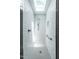 A newly remodeled shower with tile walls and floors, a shower head, and a built-in niche at 5809 Kimbal St, Raleigh, NC 27606