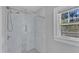 Shower room featuring marble tile with an integrated wall niche and a shower head at 602 Dunbar St, Durham, NC 27701