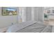 Bedroom view with mounted TV, light gray walls, and view into the kitchen at 602 Dunbar St, Durham, NC 27701