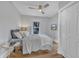 Cozy bedroom with a ceiling fan, closet, and a large window offering ample natural light at 602 Dunbar St, Durham, NC 27701