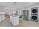 Bright kitchen featuring an island with seating, stainless steel appliances, and wood flooring at 602 Dunbar St, Durham, NC 27701