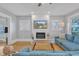 Cozy living room with a fireplace, TV, and comfortable blue sectional sofa for relaxing evenings at 602 Dunbar St, Durham, NC 27701