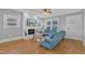 Bright living room features hardwood floors, a fireplace, and a comfortable blue sectional sofa at 602 Dunbar St, Durham, NC 27701