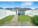 Private backyard with green lawn, white fencing, and a concrete patio at 6536 Perry Creek Rd, Raleigh, NC 27616