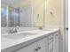 Bright bathroom featuring double sinks with white marble countertop and white cabinets at 6536 Perry Creek Rd, Raleigh, NC 27616