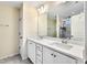 Bright bathroom featuring double sinks with white marble countertop and white cabinets at 6536 Perry Creek Rd, Raleigh, NC 27616