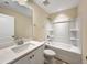 Bathroom features white cabinets, quartz countertops, and a shower-tub combo at 6536 Perry Creek Rd, Raleigh, NC 27616