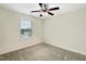 Cozy bedroom has neutral carpet, ceiling fan, and a bright window at 6536 Perry Creek Rd, Raleigh, NC 27616