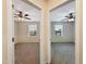 Two bedrooms featuring neutral carpet, a ceiling fan, and a window with blinds at 6536 Perry Creek Rd, Raleigh, NC 27616