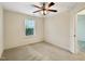 Bedroom with a ceiling fan, a window, and neutral carpet at 6536 Perry Creek Rd, Raleigh, NC 27616