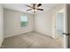 Bedroom featuring a ceiling fan, neutral carpet and a window at 6536 Perry Creek Rd, Raleigh, NC 27616