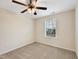 Carpeted bedroom includes a ceiling fan and window for natural light at 6536 Perry Creek Rd, Raleigh, NC 27616