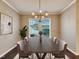 Dining room features a chandelier, natural light, neutral paint color, and hardwood floors at 6536 Perry Creek Rd, Raleigh, NC 27616