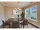Well-lit dining room features natural light, neutral paint color, stylish chairs, and hardwood floors at 6536 Perry Creek Rd, Raleigh, NC 27616
