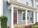 Close-up of the front door and porch of a lovely townhouse with a well-kept garden at 6536 Perry Creek Rd, Raleigh, NC 27616