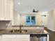 Kitchen with stainless steel appliances and granite counters overlooking living area at 6536 Perry Creek Rd, Raleigh, NC 27616