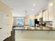 Open kitchen features white cabinets, granite countertops, stainless steel appliances, and hardwood floors at 6536 Perry Creek Rd, Raleigh, NC 27616