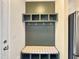 A mudroom features a built-in bench with storage and coat hooks next to stainless appliances at 6536 Perry Creek Rd, Raleigh, NC 27616