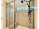 Modern walk-in shower with gray tile, a glass enclosure and shower head with handheld wand at 6536 Perry Creek Rd, Raleigh, NC 27616