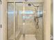 Modern walk-in shower with gray tile, a glass enclosure and shower head with handheld wand at 6536 Perry Creek Rd, Raleigh, NC 27616