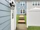 Charming townhouse entryway with modern light fixture and well-maintained landscaping at 6536 Perry Creek Rd, Raleigh, NC 27616