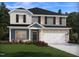 Charming two-story home with gray siding, brick accents, a two-car garage and landscaped front yard at 685 White Birch Ln, Angier, NC 27501