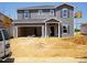 Two-story home with gray siding and a two car garage under construction at 693 White Birch Ln, Angier, NC 27501