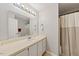 Clean bathroom with a spacious vanity, white sink, and combination shower and tub at 72 Justin Ct, Durham, NC 27705