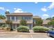 Inviting two-story townhome with neutral siding and charming blue shutters and well maintained landscaping at 72 Justin Ct, Durham, NC 27705