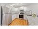 Bright kitchen features stainless steel appliances, granite countertops, and white cabinets at 72 Justin Ct, Durham, NC 27705