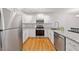 Updated kitchen with stainless steel appliances, granite countertops, and white cabinetry at 72 Justin Ct, Durham, NC 27705