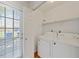 Well-lit laundry area featuring a washer, dryer, and a shelf for storage at 72 Justin Ct, Durham, NC 27705