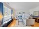 Inviting living room with a large sectional sofa, piano, and ample natural light at 72 Justin Ct, Durham, NC 27705