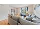Comfortable living room features a large sofa, natural light, and hardwood floors at 72 Justin Ct, Durham, NC 27705