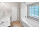 Bathroom featuring a white vanity, soaking tub, and a separate shower at 735 Sycamore Springs Dr, Fuquay Varina, NC 27526