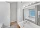 Bathroom featuring a white vanity, soaking tub, and large mirror at 735 Sycamore Springs Dr, Fuquay Varina, NC 27526