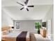 Bright bedroom featuring a ceiling fan, two windows offering ample natural light, and neutral décor at 735 Sycamore Springs Dr, Fuquay Varina, NC 27526