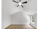 This bedroom boasts neutral carpeting, vaulted ceilings and a ceiling fan at 735 Sycamore Springs Dr, Fuquay Varina, NC 27526