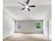 Bright bedroom featuring a ceiling fan, two windows offering ample natural light, and neutral décor at 735 Sycamore Springs Dr, Fuquay Varina, NC 27526