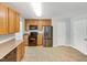 Bright kitchen with stainless steel appliances, ample wooden cabinetry, and tiled flooring at 735 Sycamore Springs Dr, Fuquay Varina, NC 27526