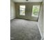 Bedroom with wall-to-wall carpet and natural light from two windows at 7832 Averette Field Dr, Raleigh, NC 27616