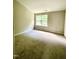 Bedroom with neutral walls, carpet flooring, and a bright window offering natural light at 7832 Averette Field Dr, Raleigh, NC 27616