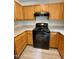 Modern kitchen featuring granite countertops, stainless steel appliances, and sleek black oven range at 7832 Averette Field Dr, Raleigh, NC 27616